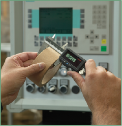 Using calipers to precisely measure the length of a core